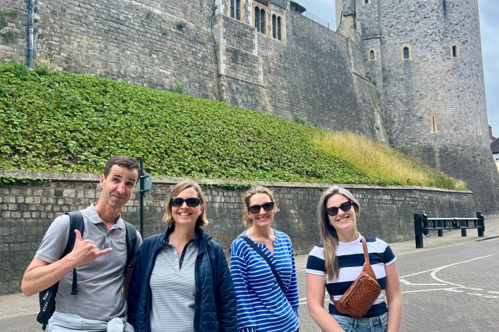 a group of people standing in front of a castle