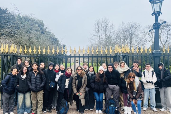 a group of people standing in front of a crowd posing for the camera