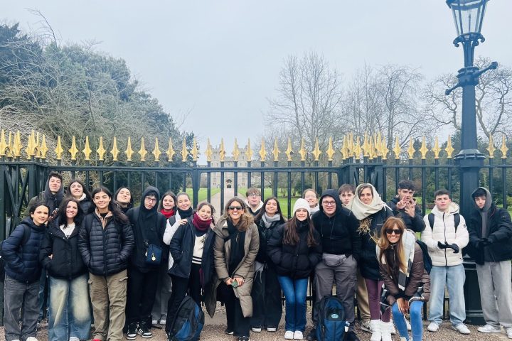 a group of people standing in front of a crowd posing for the camera