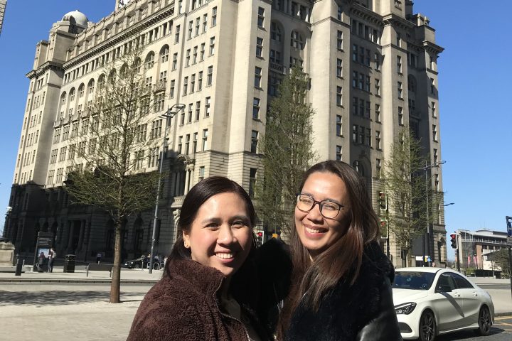 a woman standing in front of a building