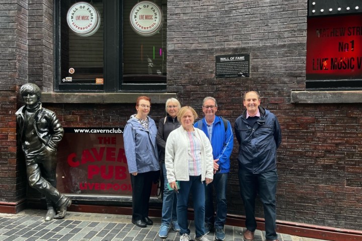 a group of people standing in front of a brick building