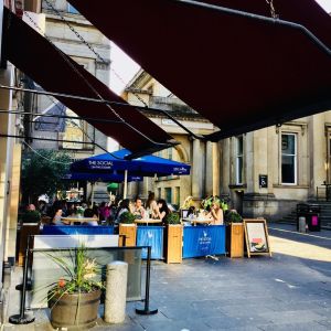 a group of people standing in front of a building