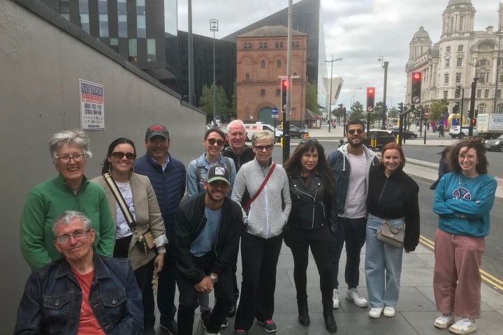 a group of people standing in front of a crowd posing for the camera