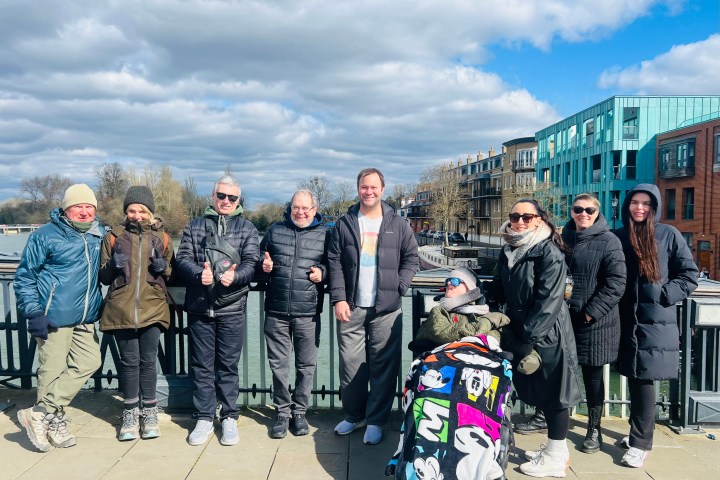 a group of people standing in front of a crowd posing for the camera