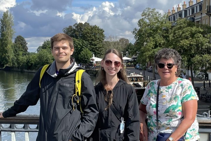 a group of people standing in front of a fence