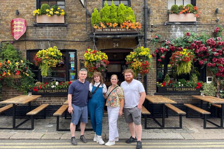 a group of people walking in front of a building