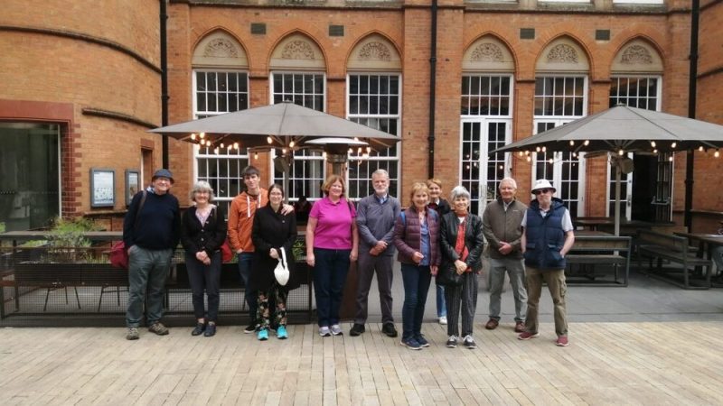 a group of people standing in front of a building