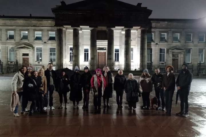 a group of people standing in front of a building