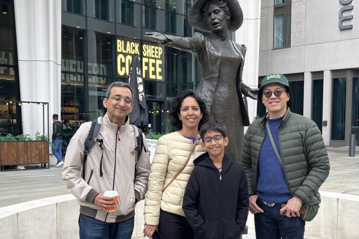 a group of people walking on a sidewalk