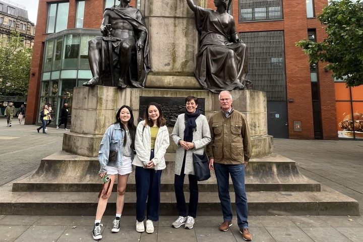 a group of people walking on a sidewalk