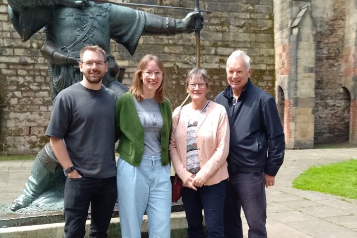 a group of people standing in front of a brick building
