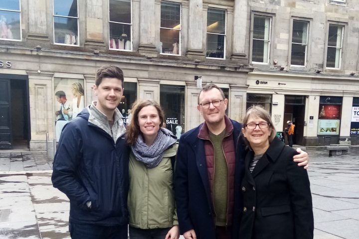 a group of people posing in front of a building