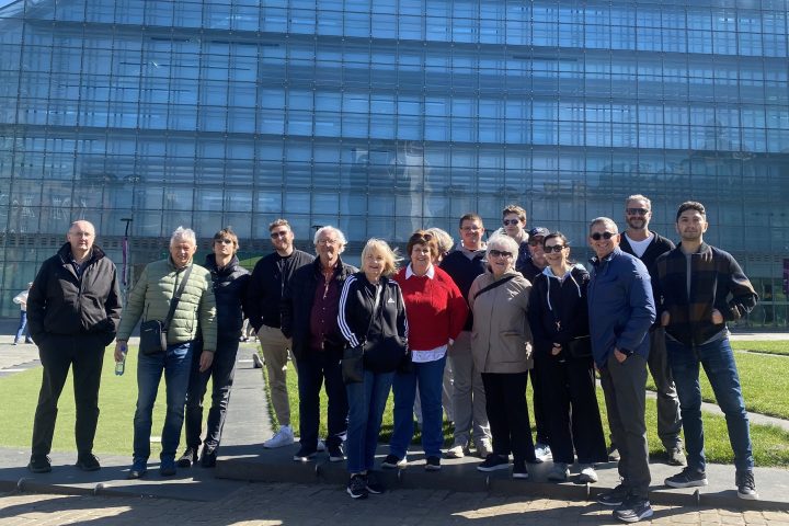 a group of people standing in front of a building