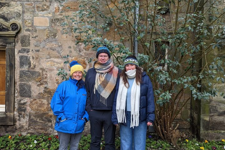 a person standing in front of a stone building