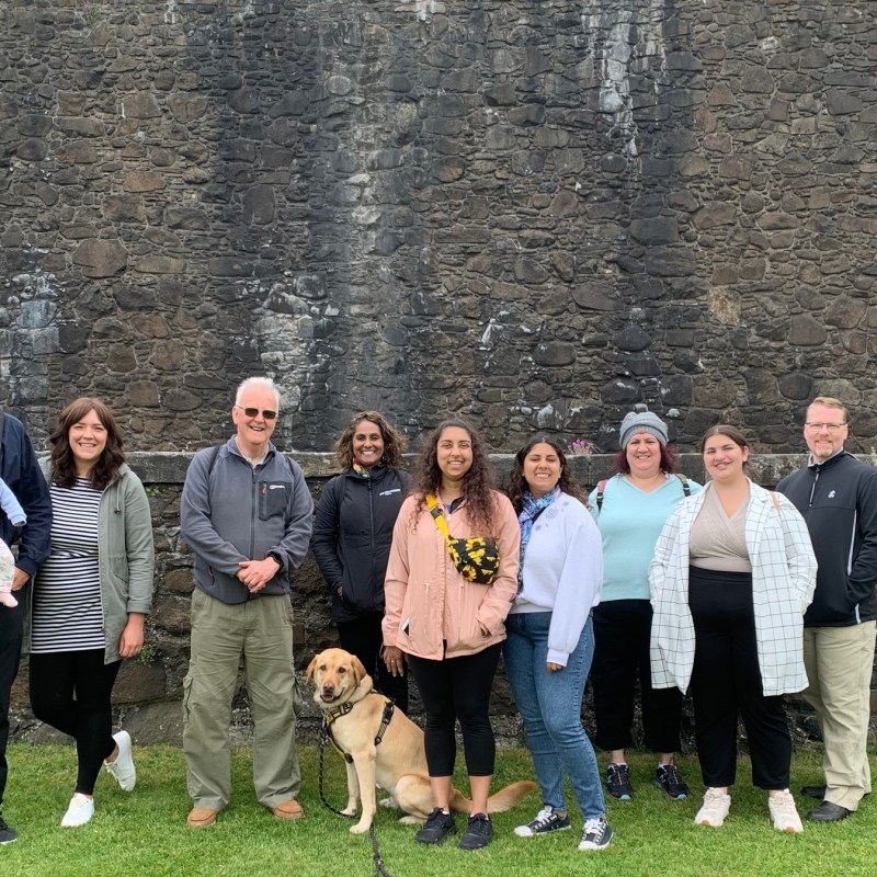 a group of people standing in front of a brick building