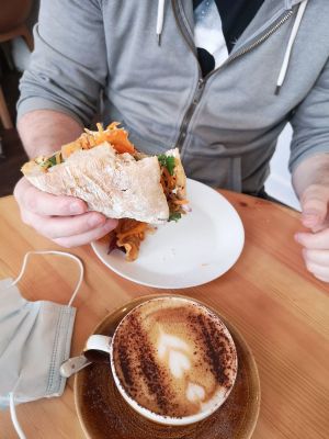 a woman sitting at a table with a plate of food