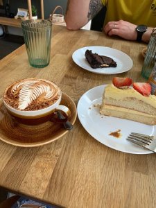 a person sitting at a table with a plate of food