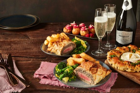a bunch of food sitting on top of a wooden table