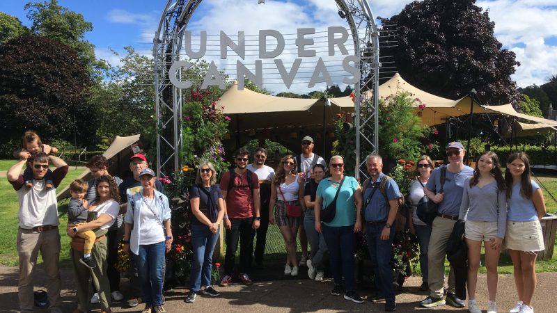 a group of people standing in front of a crowd posing for the camera