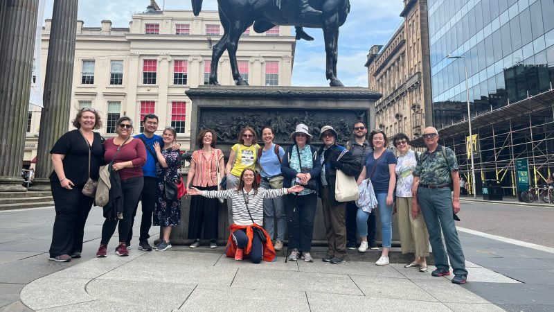 a group of people standing in front of a statue