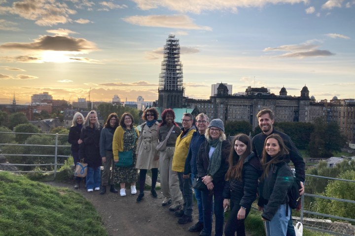 a group of people standing in front of a crowd posing for the camera