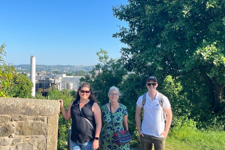 a group of people standing next to a tree