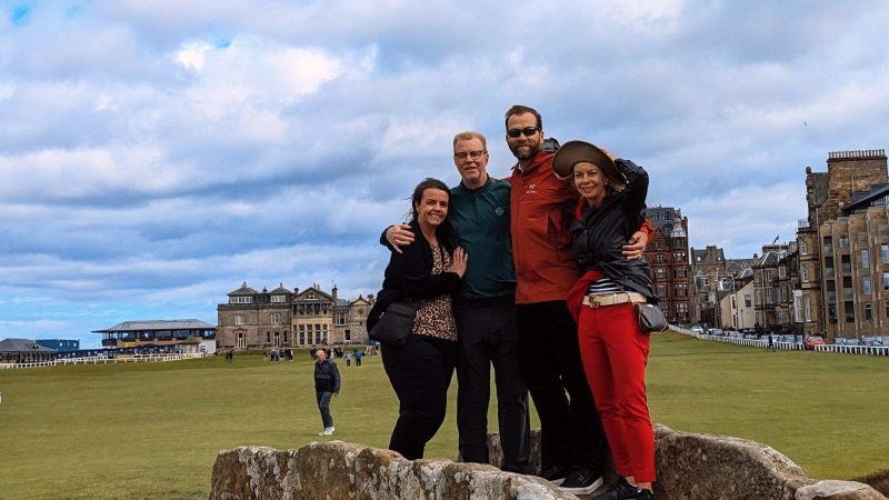 a statue of a man and a woman standing on a rock