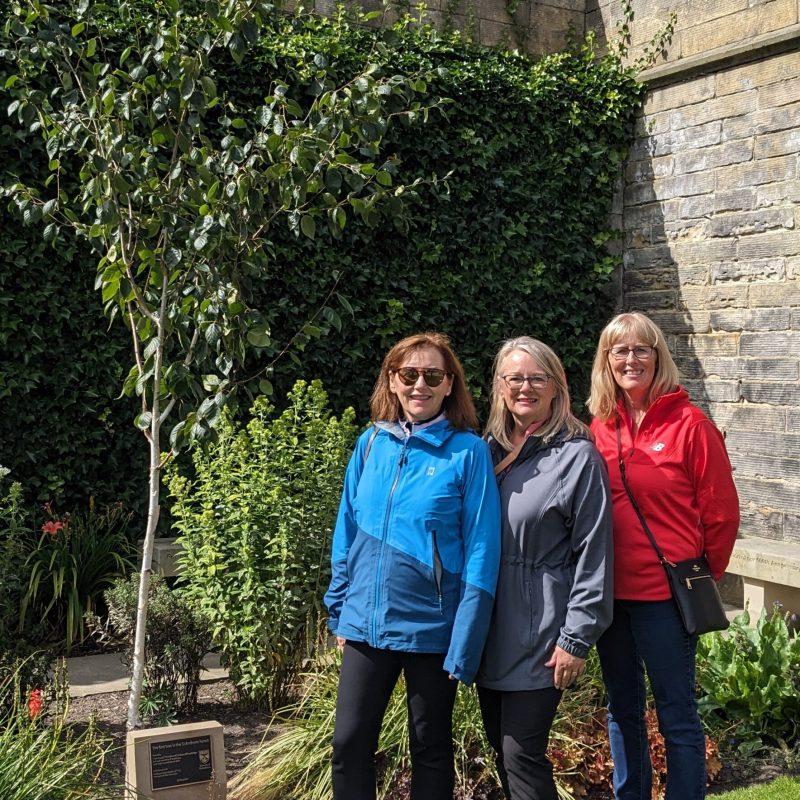 a group of people standing in front of a brick building