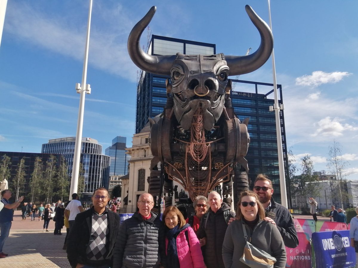 a group of people standing in front of a statue