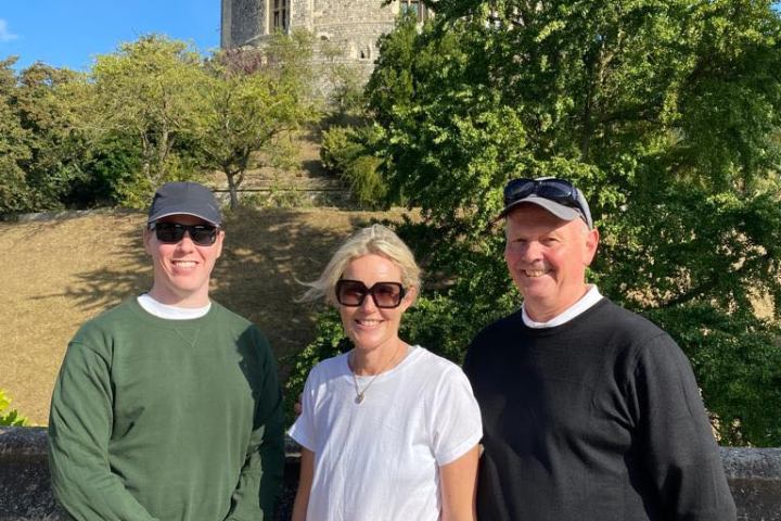 a man standing in front of a group of people posing for the camera