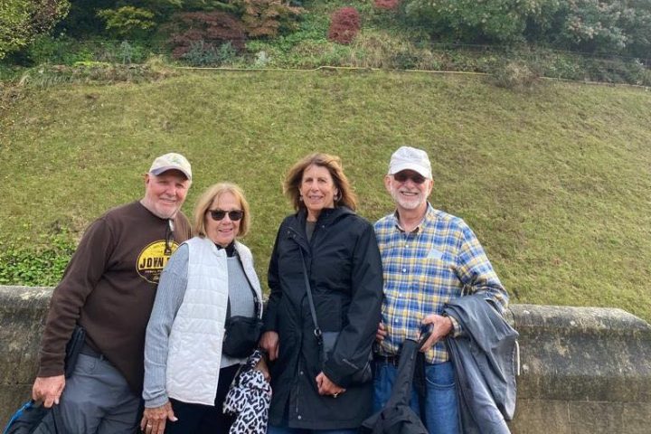 a couple of people that are standing in the grass