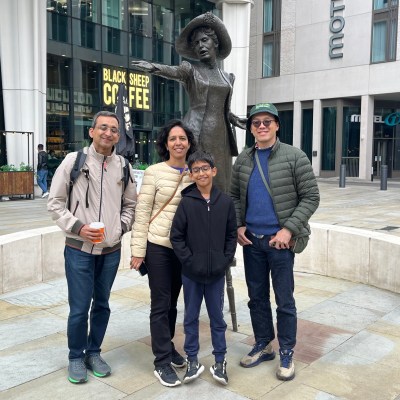a group of people walking on a sidewalk