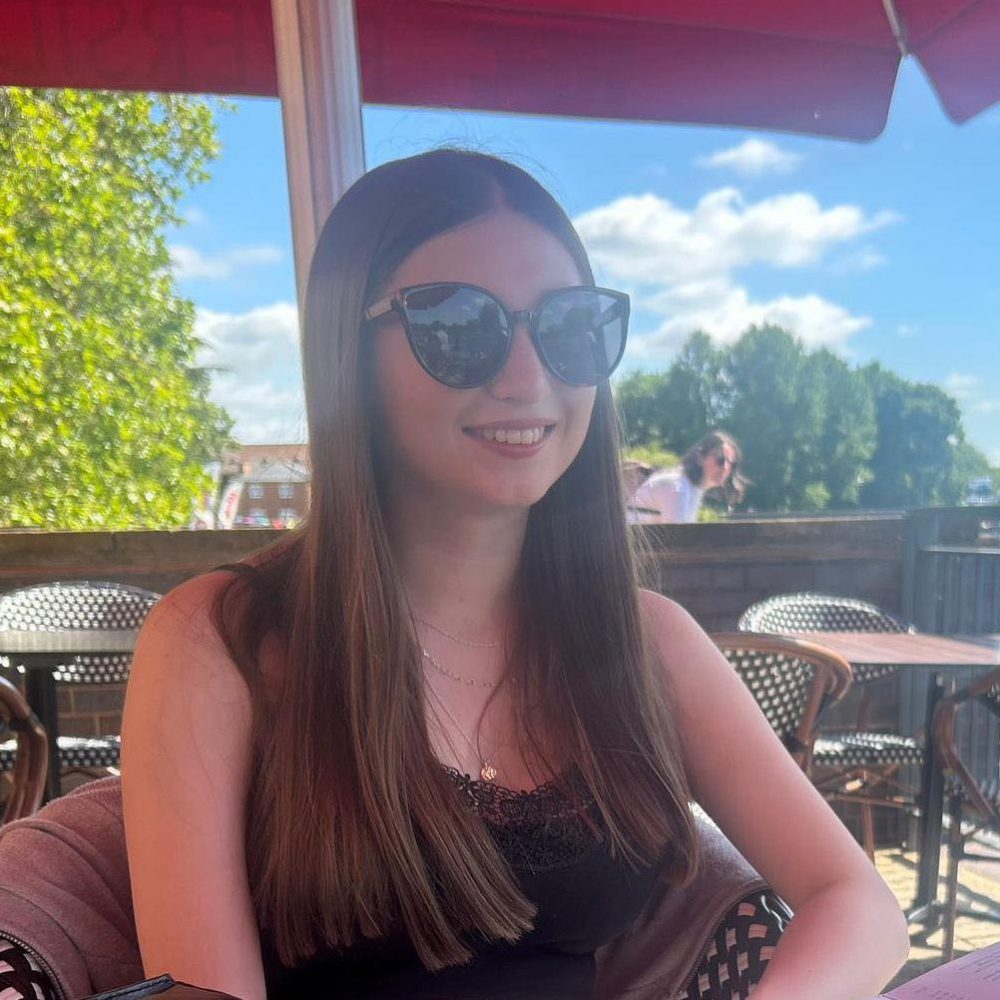 a woman in sunglasses sitting in a restaurant