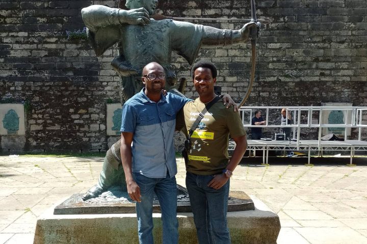 a man standing in front of a statue