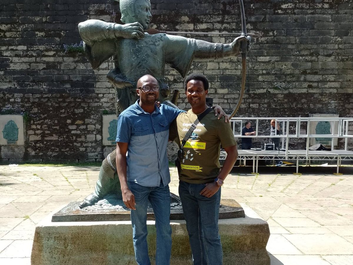 a man standing in front of a statue