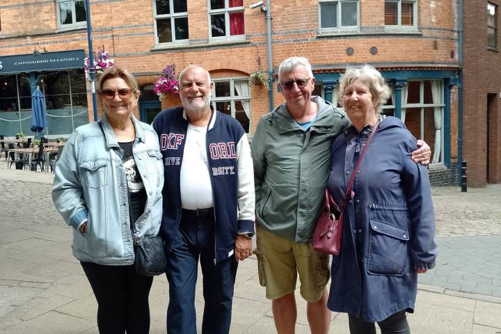 Edward Williams et al. standing in front of a building
