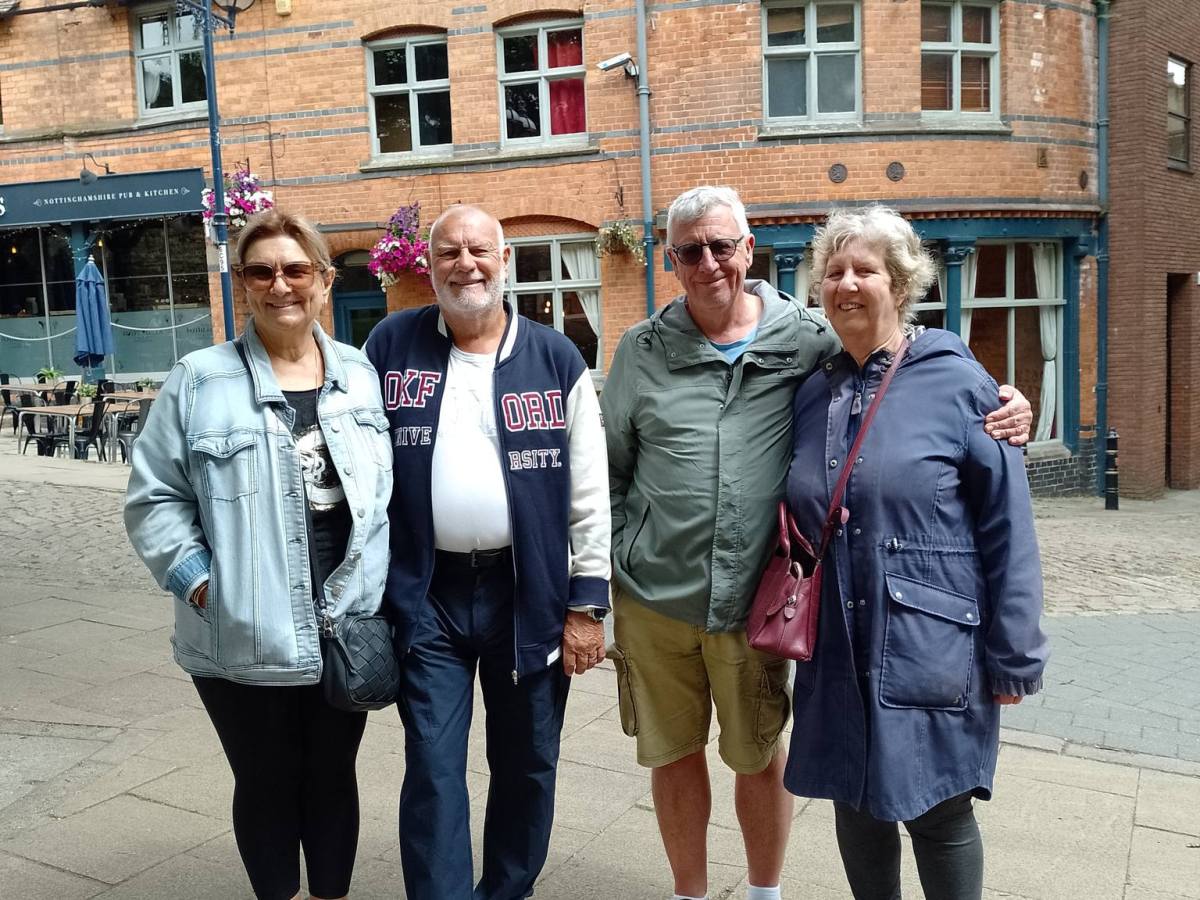Edward Williams et al. standing in front of a building