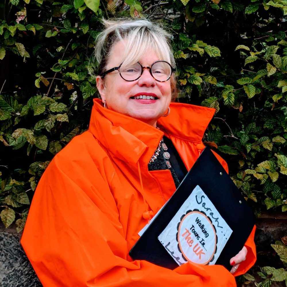 a person holding an orange umbrella