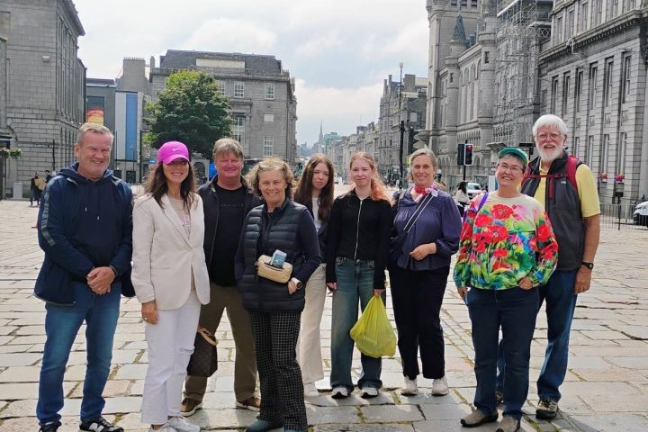 a group of people walking on a sidewalk