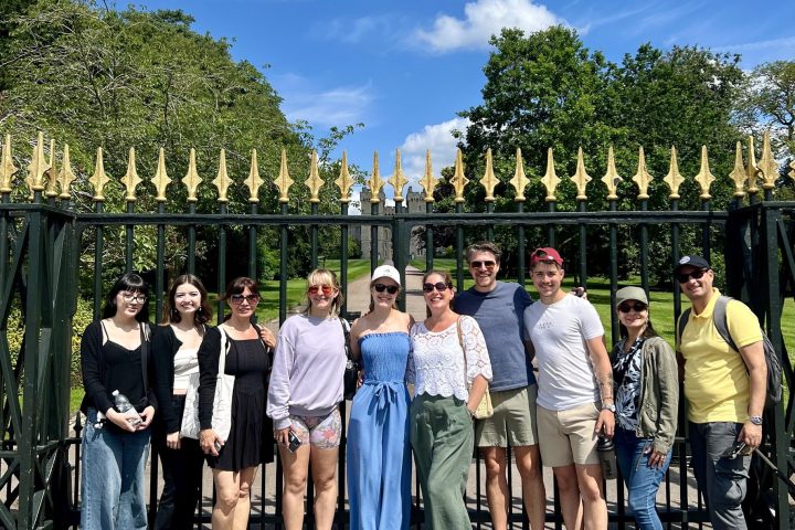 a group of people standing in front of a crowd posing for the camera