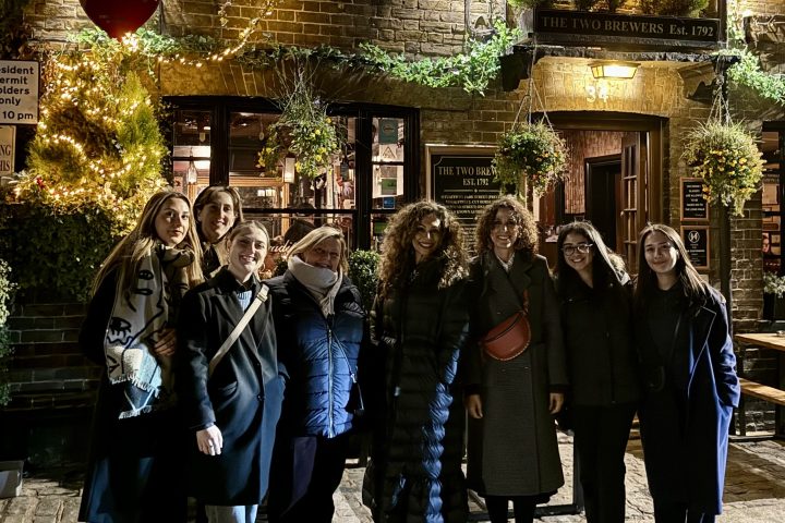 a group of people standing in front of a crowd posing for the camera