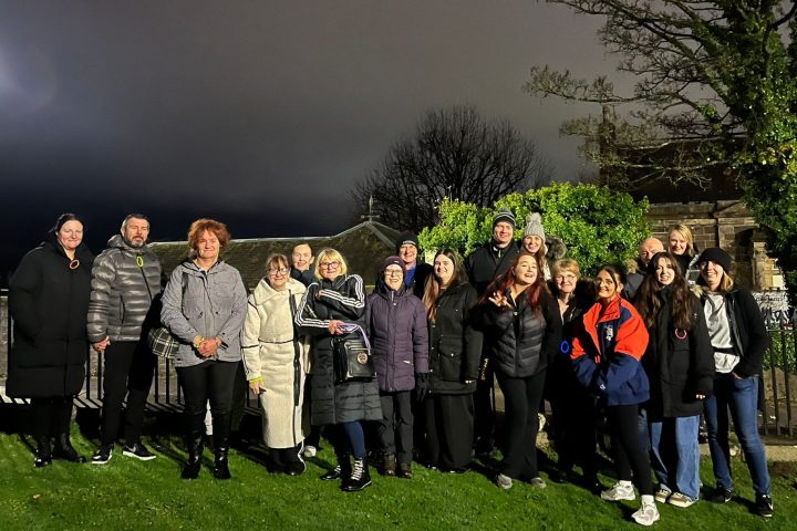 a group of people standing in front of a crowd posing for the camera