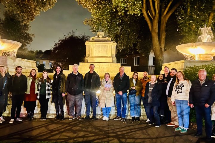 a group of people standing in front of a crowd posing for the camera