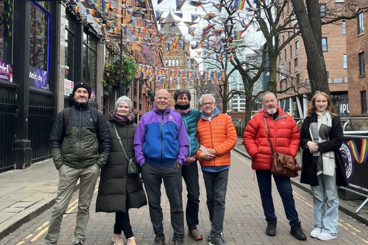 a group of people walking on a sidewalk