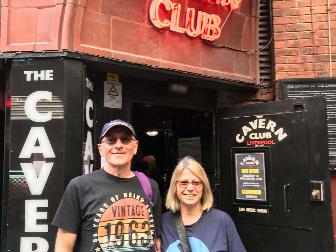 a man holding a sign posing for the camera